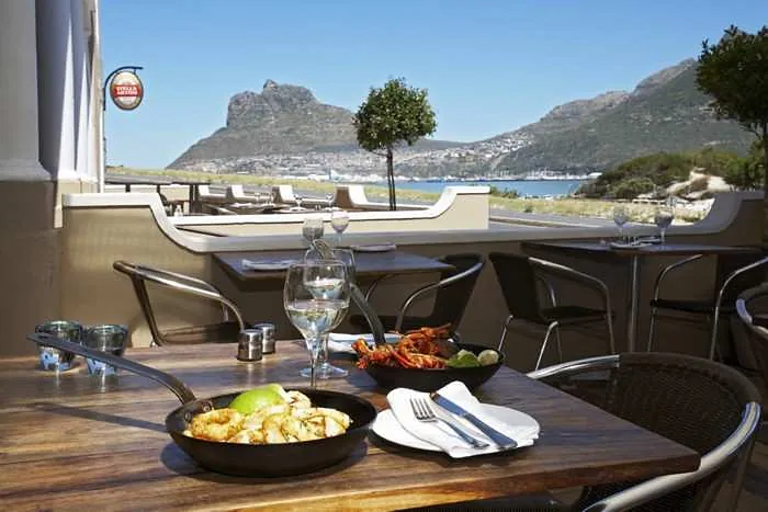 A pan of calamari on a terrace table, looking out to the Sentinel