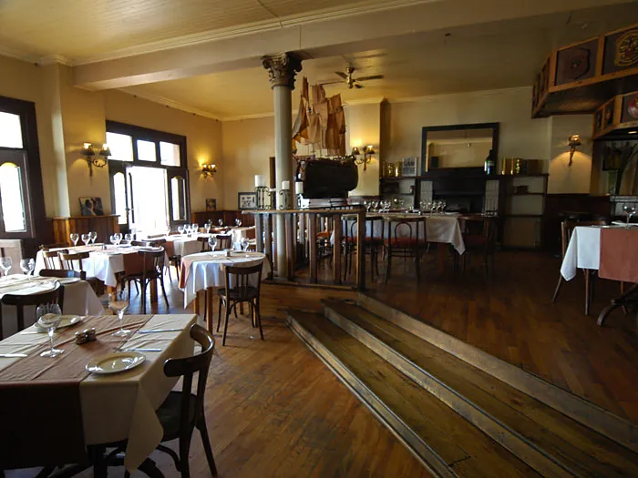 The wood-panelled dining room with its pillars and bar