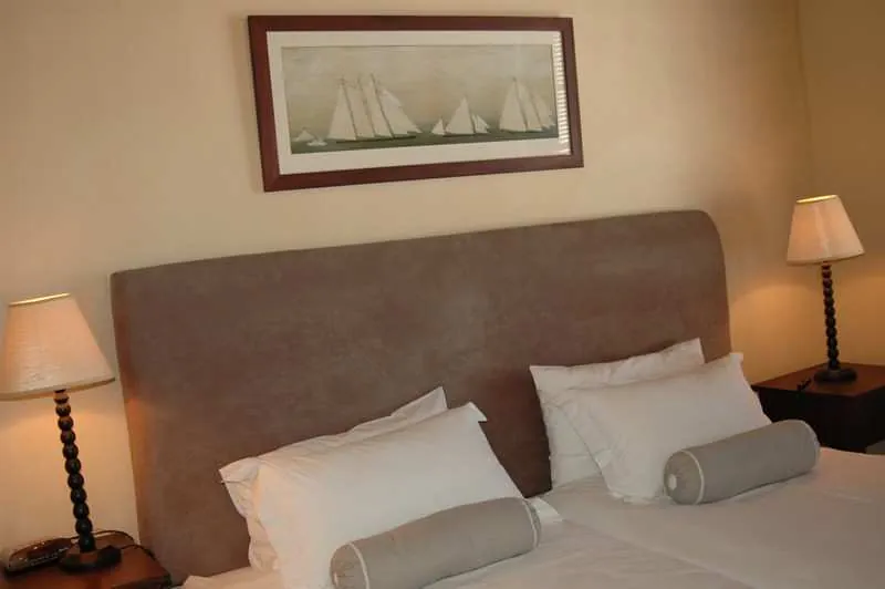 Original Room with a sailing-ship painting above the bed and bedside lamps