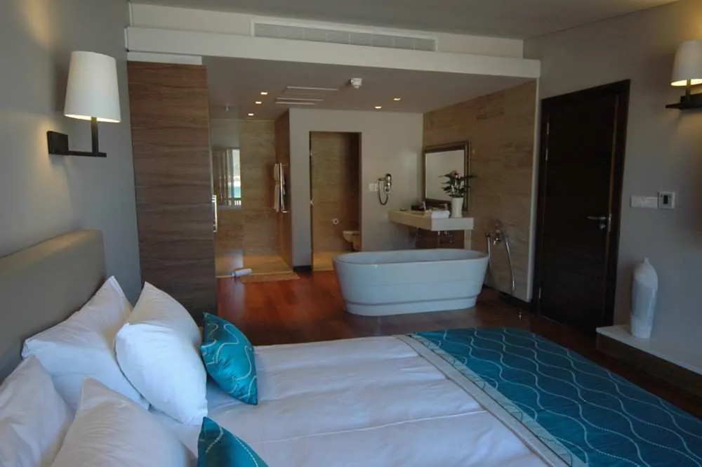 Penthouse Suite bedroom with a free-standing bath in the open-plan bathroom