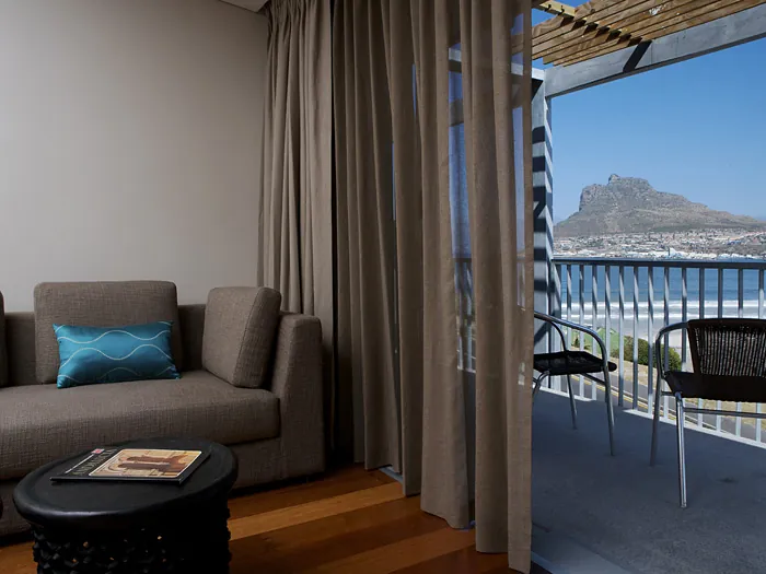Sea View Room with a sofa and an open balcony door facing the Sentinel
